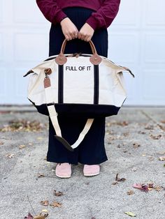 "This Weekender bag is perfect for a quick overnight trip or weekend getaway. The classic style boat tote in a variety of strap accent colors can be monogrammed or embroidered with your choice of phrases. Up to 10 characters per line, up to 3 lines of space. Choose a name, team, or my personal favorite- go with a funny phrase. So many font choices and monograms available, reach out if you don't see quite what you're after or need inspiration! 15\" H X 28\" W X 10\" D 3.45 lbs 18 oz Canvas Top zip closure with leather accent pullers Genuine leather handles Internal pocket with zipper closure Brass clips for removable shoulder strap Weekenders have a zipper closure & exterior pocket, as well as interior pockets that zip. They are sturdy and durable canvas that is made to last. with genuine l Retro Large Capacity Canvas Bag For Travel, Casual White Bag For Overnight Trips, White Tote Shoulder Bag For Overnight Trips, Casual Cotton Bags For Overnight Trips, Casual Cotton Bag For Overnight Trips, Casual White Travel Bag For Overnight Trips, Canvas Lined Tote Weekender Bag For Overnight Trips, Large Capacity Tote Duffle Bag For Overnight Trips, Rectangular Canvas Weekender Bag For Overnight Trips