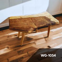 a wooden bench sitting on top of a hard wood floor