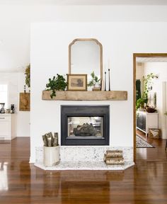 a living room filled with furniture and a fire place in the middle of a room