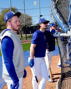 two baseball players are talking to each other