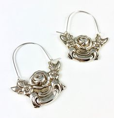 "These earrings are made from a vintage silver dish which had a beautiful embossed around the edge of flowers and other art nouveau motifs. I followed the line of the pattern into a point, drilled it and attached a sterling silver ear wire which is attached to either side of the charm. One side is hooked and unloops from the other side for you to insert the ear wire, and then clip it back up. They are very lightweight but are so eye catching. Measurements: Charm Length: 53 mm / 2.08\" Charm Widt Vintage Hoop Earrings For Gift, Handmade Vintage Hoop Earrings For Anniversary, Vintage Handmade Hoop Earrings For Anniversary, Handmade Vintage Small Hoop Earrings, Vintage Hoop Earrings With Ear Wire, Vintage Small Hoop Earrings, Vintage Silver Hoop Jewelry, Handmade Small Hoop Vintage Earrings, Silver Engraved Hoop Earrings For Gift