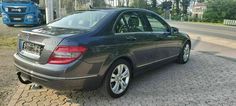 a mercedes c - class is parked on the side of the road