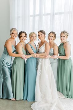 the bride and her bridesmaids pose for a photo