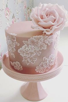 a pink wedding cake with white flowers on top and the words, 9 amazing wedding cake