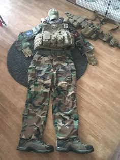 an army uniform is laying on the floor