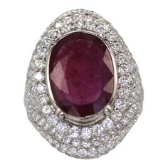 This is part of Chairish’s Fine Jewelry assortment.  RING SIZE: 6.5 WEIGHT: 13.5 grams MAIN STONE: Ruby 4.58 cts OTHER STONES: Diamonds 4.02 cts, VS1 clarity, G-H color METAL: 18k white gold  Ruby & Diamond Ring 18k White Gold. This unusually large, transparent ruby has a very large table with a small depth. So, although it is 4.58 carats, it presents as an 8 carat stone. As is typical of most rubies sold after 1950, this ruby has lead glass filling (whether the seller tells you or not, most rub Lead Glass, Ruby Diamond Rings, Gold Cocktail Ring, Gold Cocktail, Large Table, Leaded Glass, Ruby Diamond, White Gold Ring, Diamond Art