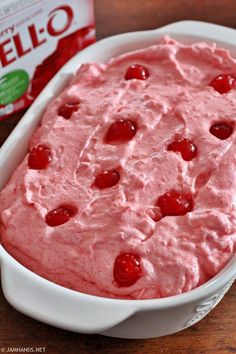 a bowl of fruit dip next to a carton of jello