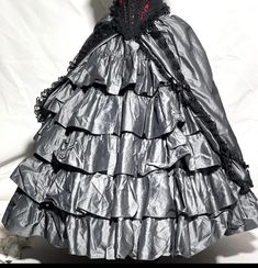 #C8/5, H5/4 this 2 pcs steampunk gothic outfit Ballroom steel Grey Taffeta Skirt and Tulle net bone patticote hoop including in this sale .  skirt has 3 layers and with black 3D roses Braiding all the way round the apron (top layer), 2nd layers is tiered and it's fully lined. Waist is elasticated with toggle for waist adjustment. Skirt is one size  Boned under skirt with 2 black Tula layers (please refer to photos) and has valcro fasteners.  Skirt front and back length. - 41" approximately  Plea Gothic Black Skirt For Larp, Steampunk Halloween Costume Skirt, Fitted Gothic Skirt For Fantasy Events, Steampunk Costume Skirt With Attached Cancan, Gothic Petticoat For Halloween Costume Party, Gothic Skirt For Halloween Costume, Gothic Halloween Costume Skirt, Steampunk Corset Dress With Ruffles For Halloween, Black Gothic Petticoat For Cosplay