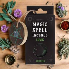 some herbs are on a table and there is a tag that says magic spell incense luck