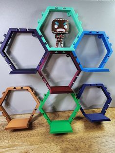 an assortment of hexagonal shelves on a wooden floor with a key in the middle