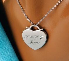 "Our silver engraved heart necklace is a great personalized gift for that special someone. Great for Bridesmaids, Flower Girls, Best Friends, or the love of your life. Engrave the heart with names, dates or a message of love. Both sides of the heart pendant can be engraved. Silver Heart Necklace Dimensions: 1.1\" X 1\" Material High Polished Silver Stainless Steel with CZ How To Send Engraving Instructions: When you are ready to order click ADD TO CART. During checkout fill out the ADD A NOTE se Heart-shaped Wedding Necklace With Engraving Option, Heart Shaped Wedding Necklace With Engraving Option, Engraved Heart Pendant Charm Necklace For Anniversary, Engraved Necklaces For Wedding On Valentine's Day, Heart Cut Heart Charm Necklace For Wedding, Personalized Stainless Steel Heart Necklace For Anniversary, Heart Pendant Necklace With Engraving Option For Wedding, Stainless Steel Heart Charm Necklace For Anniversary, Stainless Steel Heart Pendant Charm Necklace For Anniversary