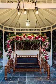 a gazebo decorated with flowers and greenery