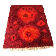 an area rug with red flowers on it