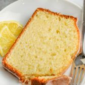 a slice of lemon bread on a plate with a fork and knife