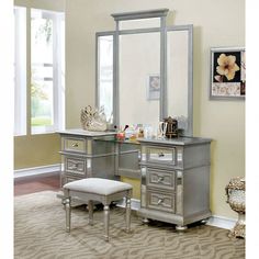 a silver vanity with mirror and stool in a room