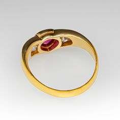 This beautiful ring is centered with one (1) pear cut natural ruby set into a bezel. The center stone is flanked to each side by one (1) channel set round brilliant cut diamond. The ring measures 5.5mm at the top and rises 4.0mm above the finger, tapering to 2.0mm wide and 0.5mm thick at the base of the shank. It is currently a size 4.25. Classic Three Stone Ruby Ring With Diamonds, Formal Ruby Ring With Diamond Bezel Setting, Formal Bezel Set Ruby Diamond Ring, Formal Ruby Diamond Ring With Bezel Setting, Classic Ruby Ring With Bezel Setting, Classic Three Stone Ruby Ring For Formal Occasions, Fine Jewelry Ruby Ring For Anniversary, Ruby Ring With Diamond Bezel Setting, Fine Jewelry Ruby Ring With Tension Setting For Anniversary