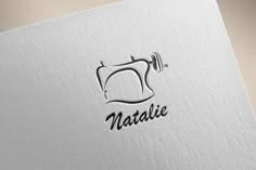 a logo for a sewing machine that has the word natalie on it's side