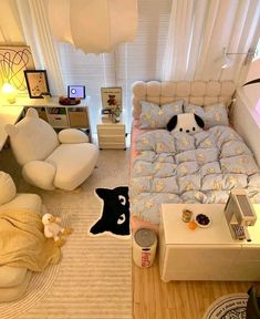 a bedroom with white furniture and lots of stuffed animals on the bed in front of it