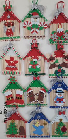 christmas decorations made out of popsicle sticks and wood are hanging on a white wall