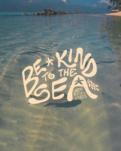 a sticker that says be kind to the sea in white lettering on a sandy beach