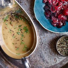 there is a bowl of food on the table next to other bowls and spoons