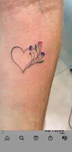 a small heart tattoo with flowers on it