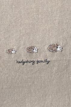 three hedgehog family embroidered on the back of a linen t - shirt that says,'hedgehog family '