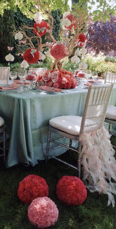 the table is set with red and white flowers