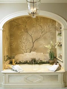 a bath room with a chandelier and a tree on the wall