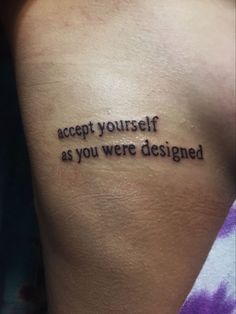 a woman with a tattoo saying accept yourself as you were designed