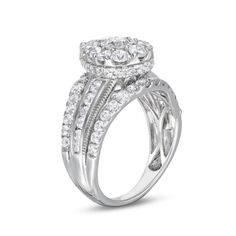 a white gold ring with two rows of diamonds on the band and an oval shaped center stone