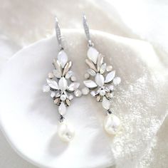 Add a vintage touch to your bridal look with these unique crystal bridal earrings!  - Handcrafted with Premium European crystals  - Each stone is set by hand in my studio - White opal, Golden shadow, Clear and Ivory cream stones along with Crystal pearls - Earrings measure 2" x 0.75" - Available in antique silver, rose gold and antique gold - Handcrafted in the US. - Nickel free and hypoallergenic - PLEASE ALLOW APPROX 10 BUSINESS DAYS FOR COMPLETION BEFORE SHIPPING  This is an original design b Exquisite Jeweled Earrings For Wedding, White Crystal Embellished Bridal Earrings For Wedding, Vintage Silver Crystal Earrings For Wedding, White Crystal Embellished Wedding Earrings, White Crystal Embellished Earrings For Anniversary, White Sparkling Crystal Bridal Earrings, Sparkling White Crystal Bridal Earrings, Crystal Embellished Drop Earrings For Wedding, Elegant White Jeweled Earrings