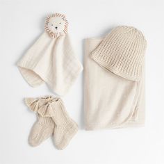 a baby's outfit, hat and booties are laid out