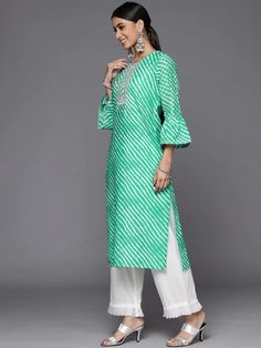 This is a single piece kurta. It comes with straight shape kurta comes with floral print detailing has round neck, 3/4th sleeves & calf length. Single Piece Color-Green Suit Fabric-Cotton Work - Leheriya Print & Gota Patti Detailing Neck-Round Neck Sleeves-3/4th Flared Sleeves Kurta Length - Calf Length Washing Care - Hand Wash Size worn by the model: Small Height: 5'7" Festive Kurta With 3/4 Sleeves, Festive Kurta With Printed Motifs And 3/4 Sleeves, Festive Kurta With 3/4 Sleeves And Printed Motifs, Festive 3/4 Sleeve Kurta With Printed Motifs, Festive Kurta With 3/4 Sleeve For Eid, Festive 3/4 Sleeve Kurta For Eid, Semi-stitched Long Sleeve Kurta For Spring, Spring Printed Salwar Kameez With Straight Kurta, Spring Printed Straight Kurta Salwar Kameez