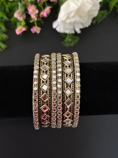 antique gold mirror bangle set (2 kade+ 4 bangles) . Plain bangles sold separately. Please message seller if you want to add 24 plain bangles. message to select color . different colors available in all sizes. can be customized in any color. Silver Metal Bracelet With Stone Work, Festive Silver Bracelets With Stone Work, Silver Bracelet With Stone Work For Festive Occasions, Silver Bracelets With Stone Work For Festive Occasions, Silver Bracelets With Stone Work For Festivals, Traditional Metal Bracelets With Stone Work, Festive Silver Bracelet With Stone Work, Metal Bangle For Festivals With Hand Set Details, Festive Metal Bangle For Festivals