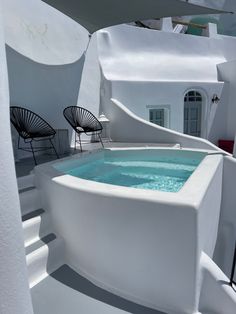 an outdoor jacuzzi is shown with chairs around it