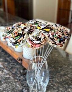 a vase filled with flowers sitting on top of a counter