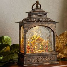 an ornately decorated lantern sits on a table