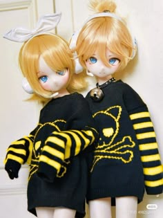 two dolls dressed in black and yellow outfits