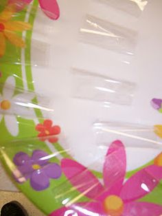 there is a plastic plate with flowers and butterflies on it, in the shape of a flower