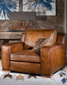 a brown leather chair sitting on top of a rug