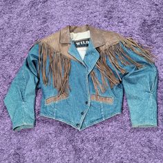 Very Good Condition. The Denim And Leather Have A Fabulous Look. Please View Pictures For Condition And Measurements. Please View Measurement Size Pictures For Size Accuracy. Some Browning Inside Cuffs, And Neck Collar Area Please View Pictures. One Leather Fringe Is Smaller Than Other Fringe. Missing One Of The Metal Parts For Tying The Fringe. Minor Issues Jrj Fall Denim Biker Jacket With Long Sleeves, Fall Denim Long Sleeve Biker Jacket, Denim Biker Jacket With Long Sleeves For Fall, Denim Long Sleeve Biker Jacket For Fall, Western Long Sleeve Denim Jacket For Fall, Western Style Long Sleeve Denim Jacket For Fall, Medium Wash Outerwear For Rodeo In Fall, Western Style Medium Wash Outerwear For Spring, Western Style Blue Winter Outerwear