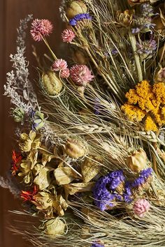 an arrangement of dried flowers on a table