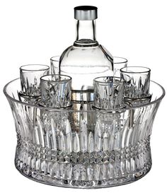 an empty bottle and glasses in a glass bowl