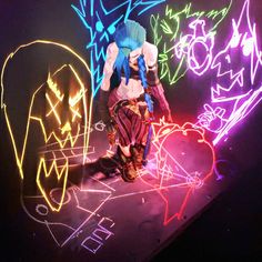 a person standing in front of neon art