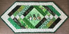 a green and white patchwork table runner