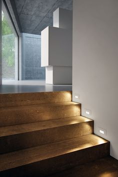 the light shines on the steps in this modern house