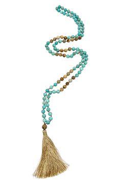 Show off boho-chic style in this long necklace composed of mixed beads in earthy hues with a tassel pendant. 38" length; 3 1/2" pendant 14k-gold plated brass/glass Imported Adjustable Bohemian Long Necklace With Tassels, Bohemian Long Necklace With Tassels, Spiritual Beaded Tassel Necklace For Beach, Beaded Tassel Necklace With Round Beads For Beach, Spiritual Beach Necklaces With Tassels, Bohemian Beige Jewelry For Meditation, Blue Bohemian Hand Knotted Necklaces, Blue Bohemian Hand-knotted Necklaces, Bohemian Tassel Necklace With Round Beads For Beach