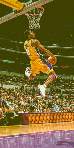 a basketball player dunking the ball in front of an arena full of people watching