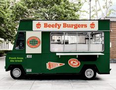 a green and white food truck parked on the street